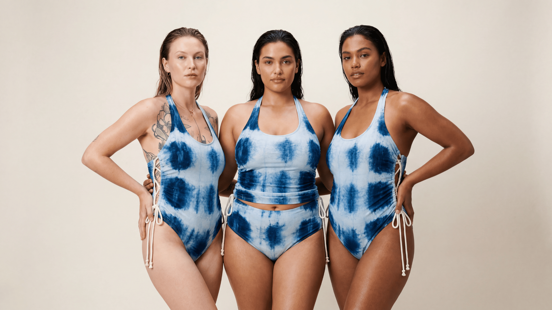 Indigo shibori-dyed natural-fibre swimsuit framed by blue florals